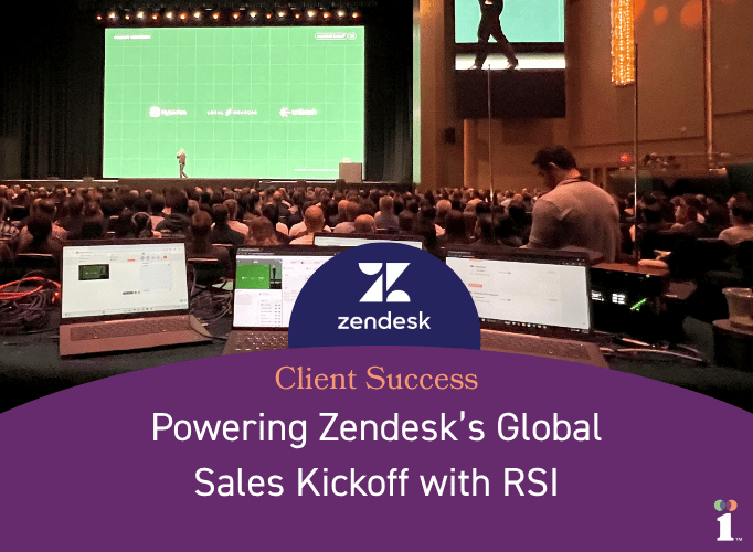 A full auditorium facing a large stage where a presenter stands in front of a bright green screen, viewed from behind several open laptops showing event control screens. Below the image, a purple panel features the Zendesk logo and the text ‘Client Success: Powering Zendesk’s Global Sales Kickoff with RSI.’