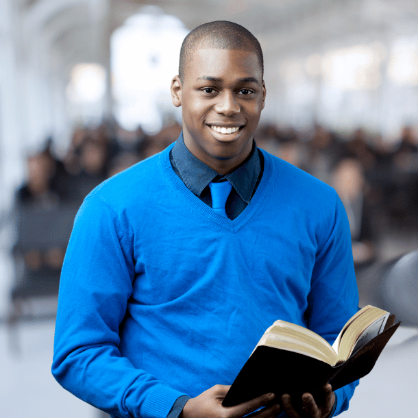 Black pastor holding a bible in a church