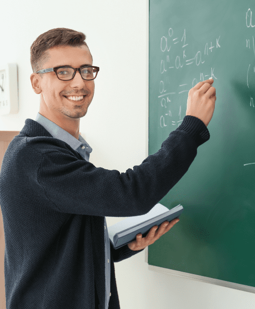 Male teacher writing in blackboard