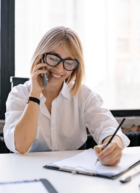 Woman speaking on the phone taking notes