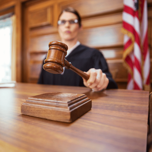Female judge in a US courtroom hitting gavel
