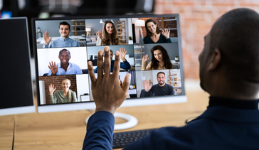 A virtual meeting attendee waving hello to the other virtual participants on his computer screen