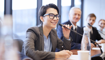 Female speaker at an in-person summit