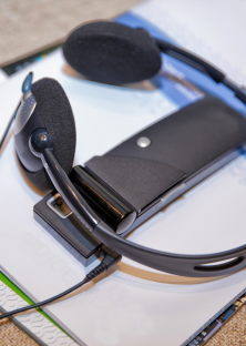 A radio headset receiver lying on a desk